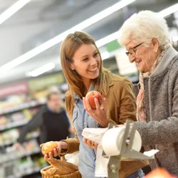 Caregiver helping a client grocery shop